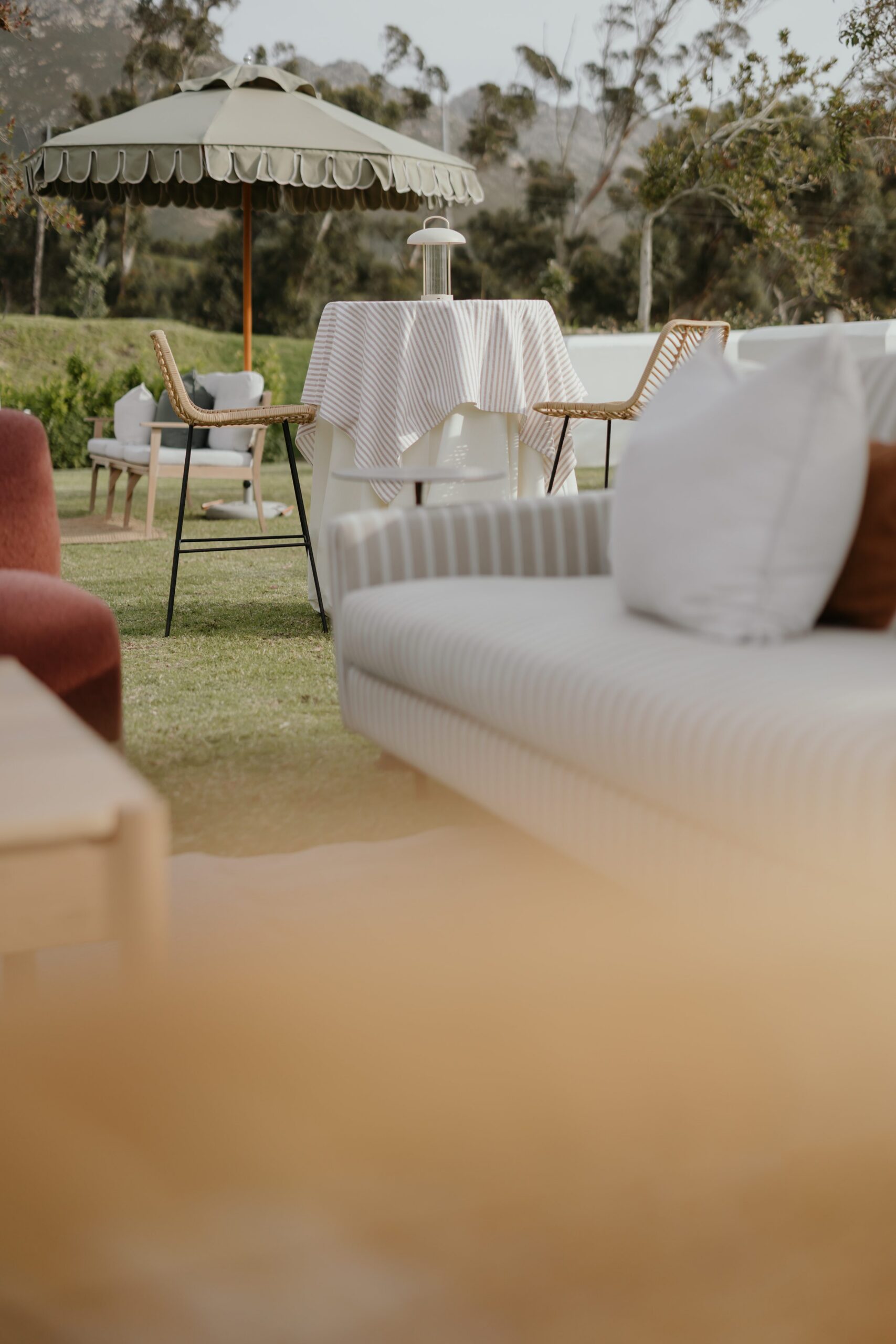 Alt tag: Outdoor event styling with lounge furniture, cocktail seating and parasol by a|CREATE