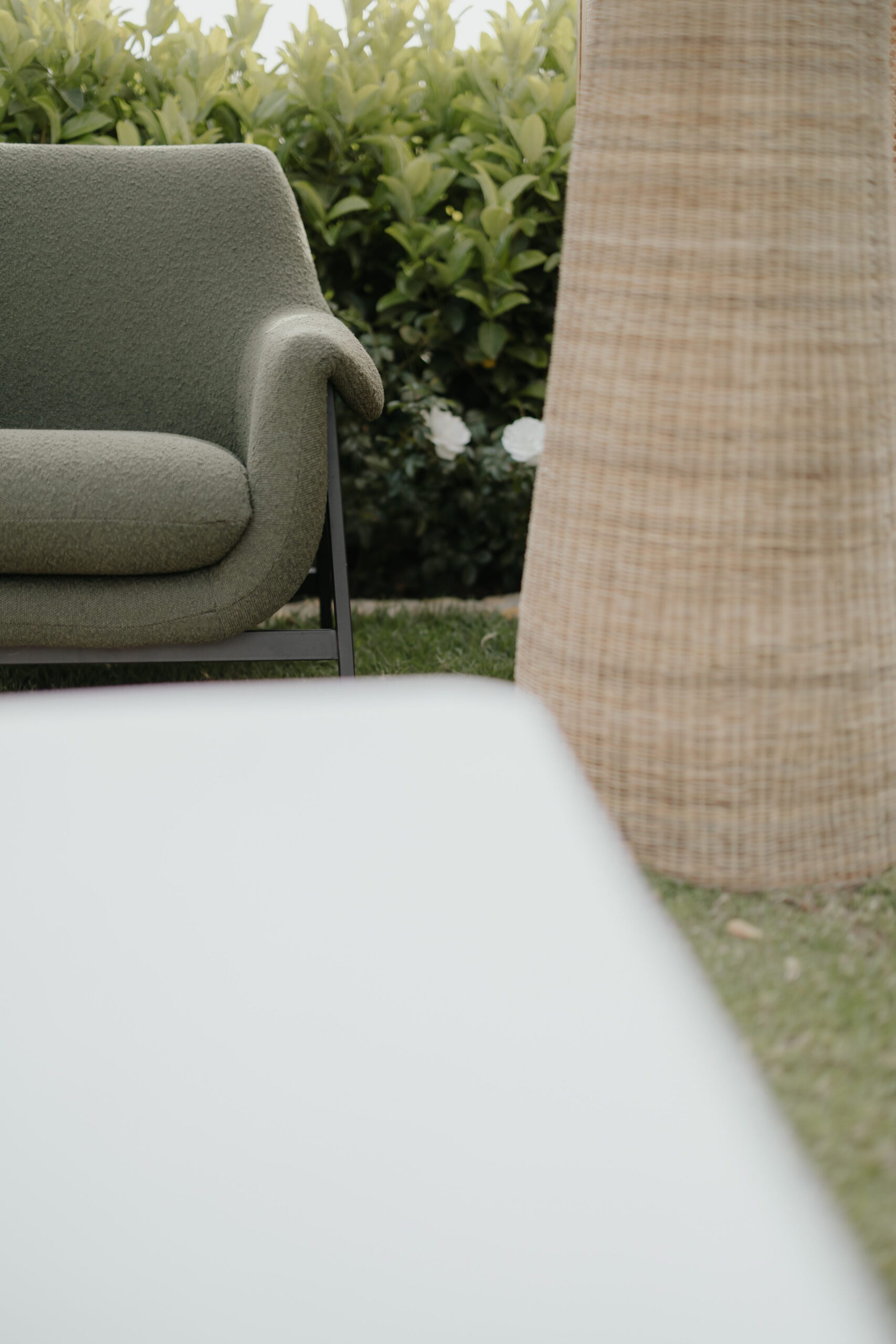 Outdoor event lounge styled with green and neutral furniture, woven décor and statement lighting by a|CREATE